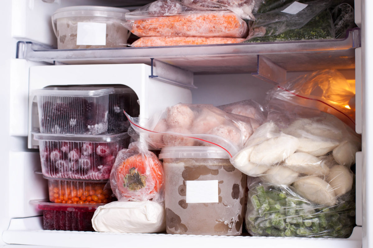 Assortment of frozen vegetables and dumplings in home fridge